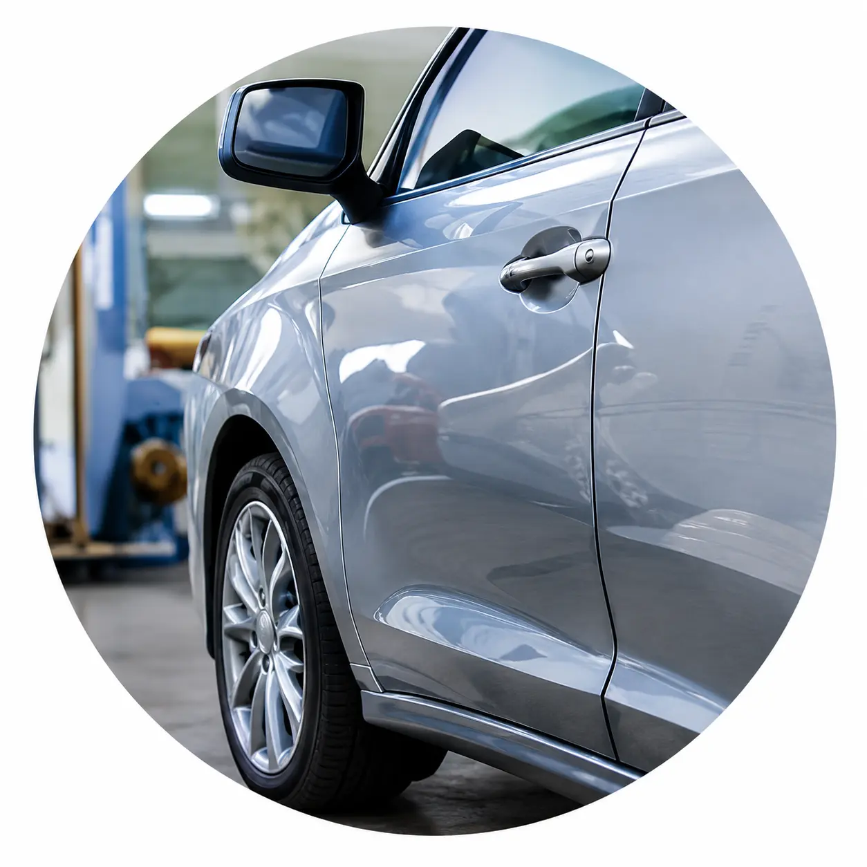 Technician repairing a dent on a car door