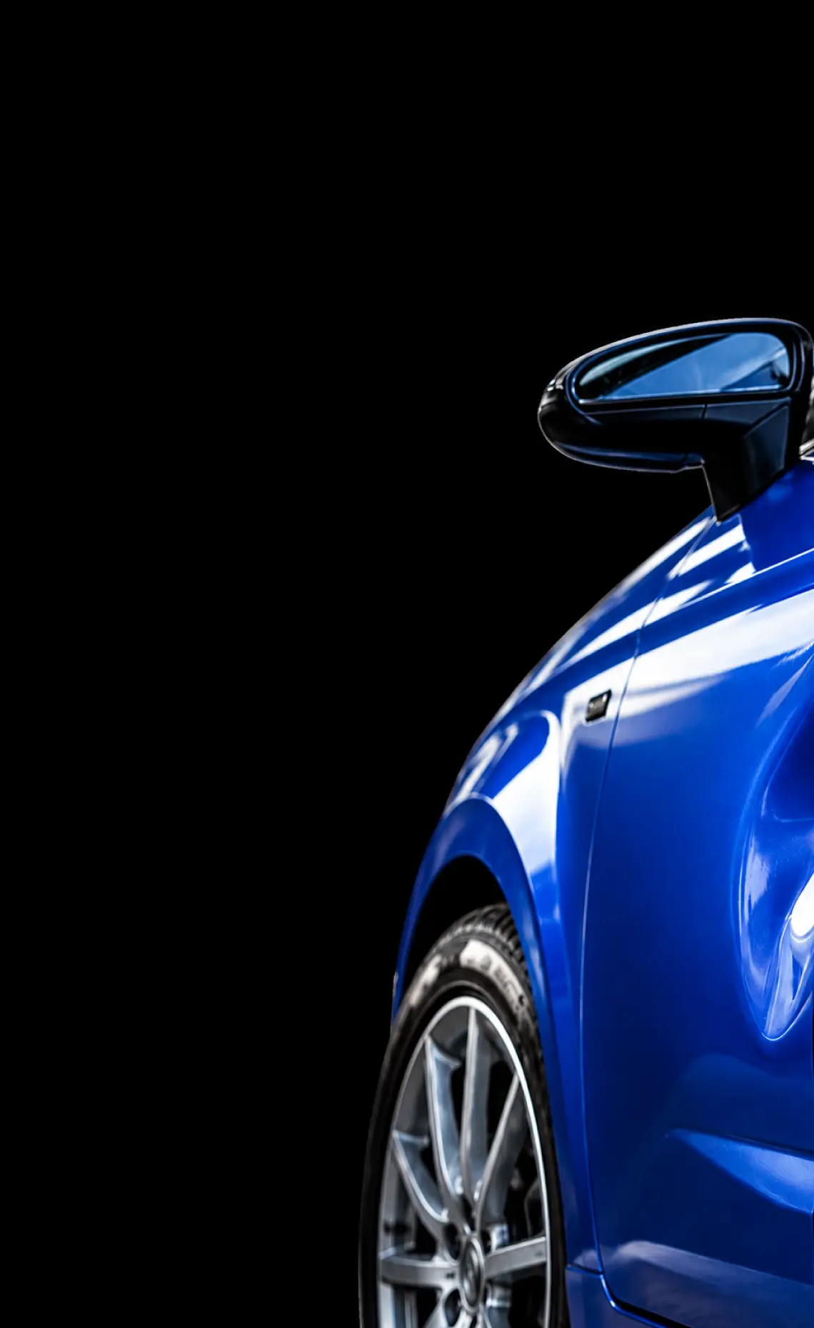 Close-up of a blue car's bodywork after paintless dent repair